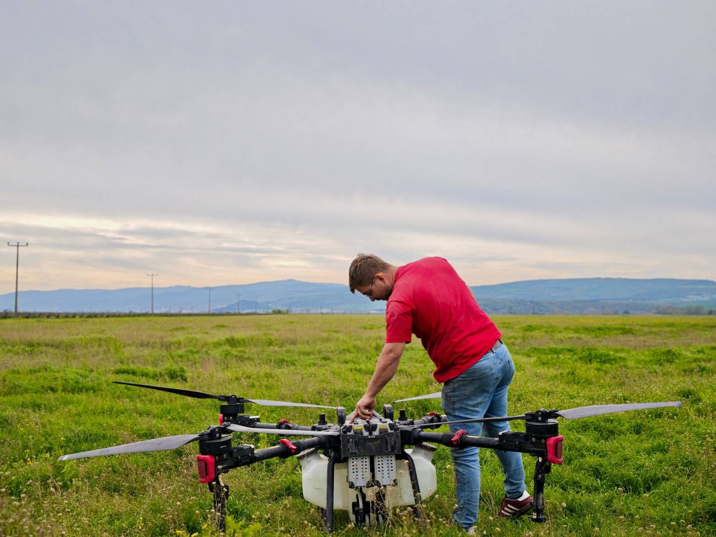 Hüseyin Armağan preps his P100 Pro drone to improve water efficiency in the rice paddy.
