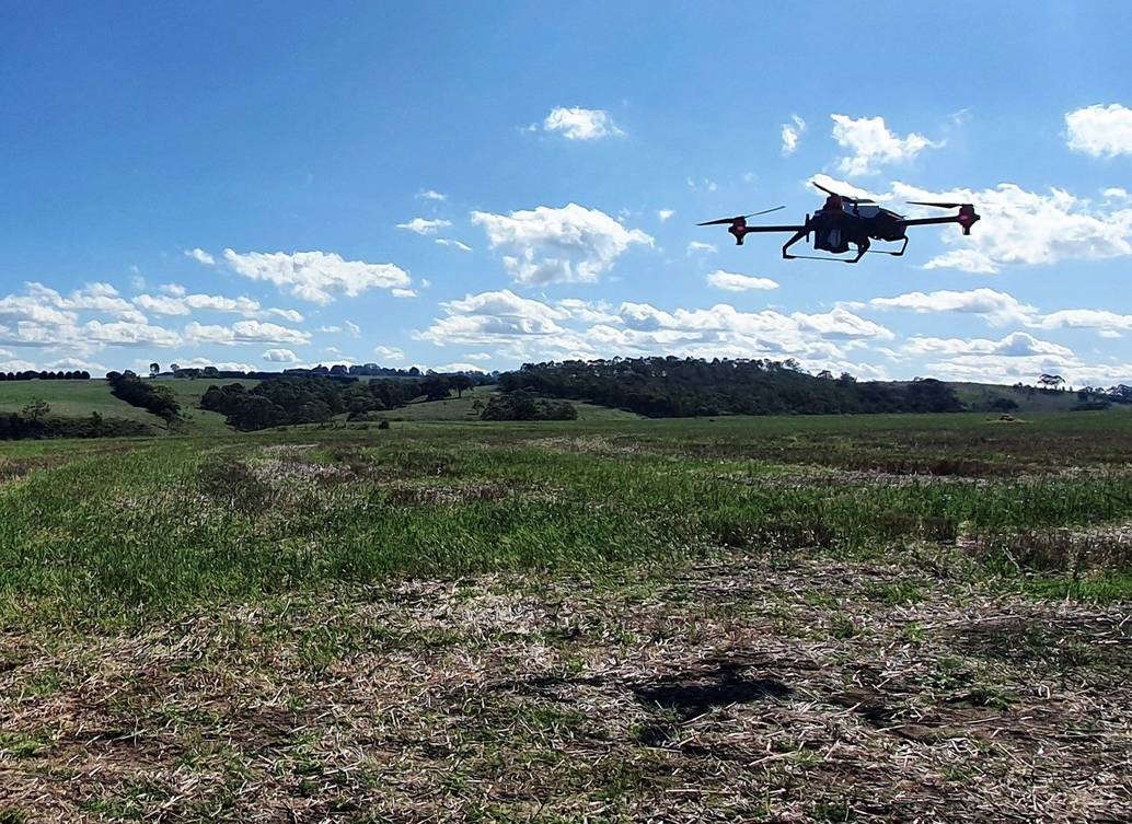 XAG drone dispersing seeds from air
