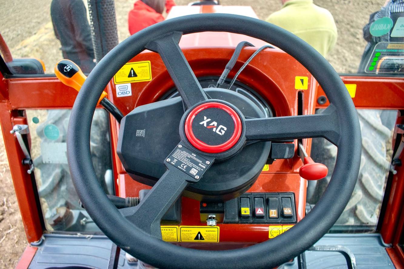 A farmer’s view inside a Tümosan tractor, equipped with XAG APC2 AutoPilot Console for hands-free, precision-guided operation.
