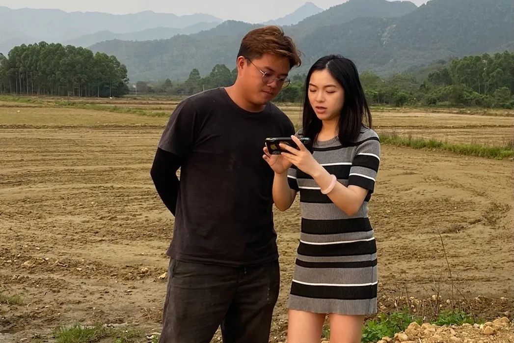 Lihua discussing her agribusiness plan with her cousin