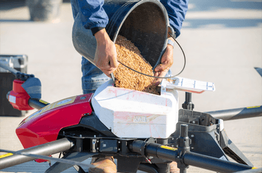 Poured rice seeds into JetSeed granule spreading system