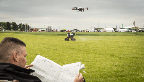 Farmer enjoys reading while the robot do the job autonomously 
